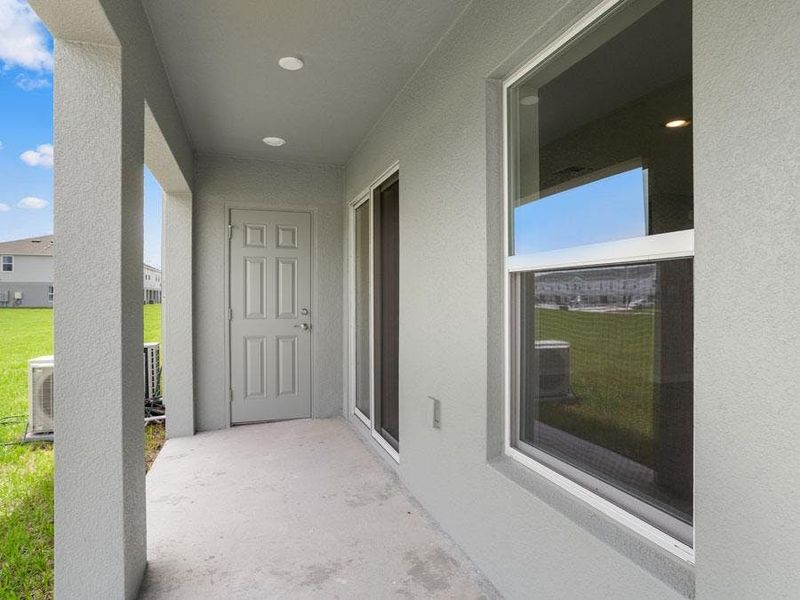Your interior opens to outdoor living space on a covered lanai with a storage closet - Bimini townhome by Highland Homes
