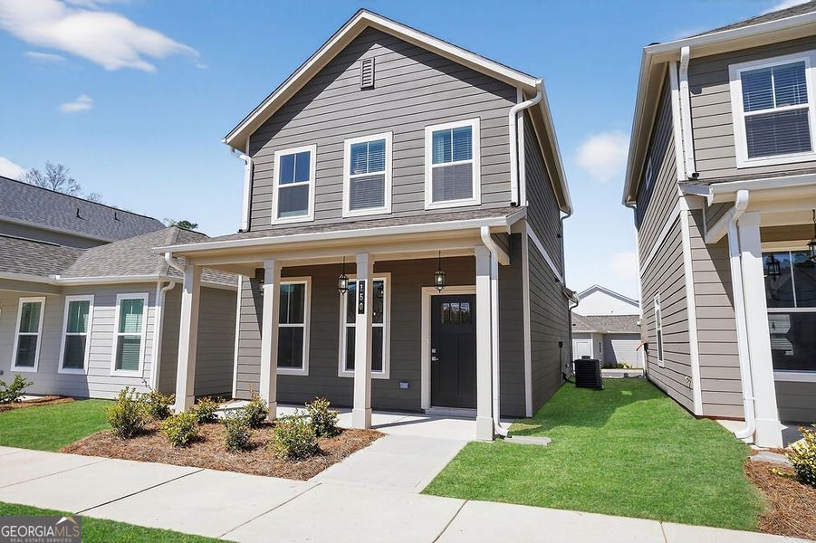 Front exterior of a new home in The Cottages at East Lanier, Fayetteville, GA, highlighting curb appeal (Image 13). Front exterior of a new home in The Cottages at East Lanier, Fayetteville, GA, highlighting curb appeal (Image 13).