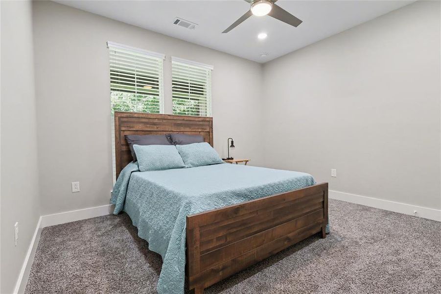 Room featuring two large windows with blinds, recessed lighting, and a ceiling fan