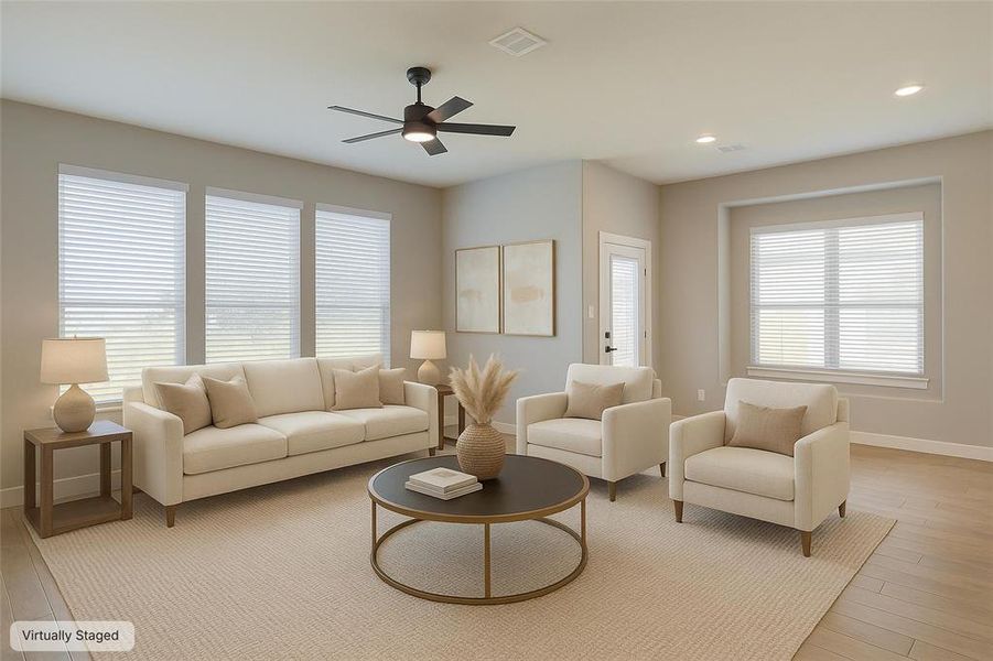 Living room with light wood-style floors, ceiling fan, and recessed lighting