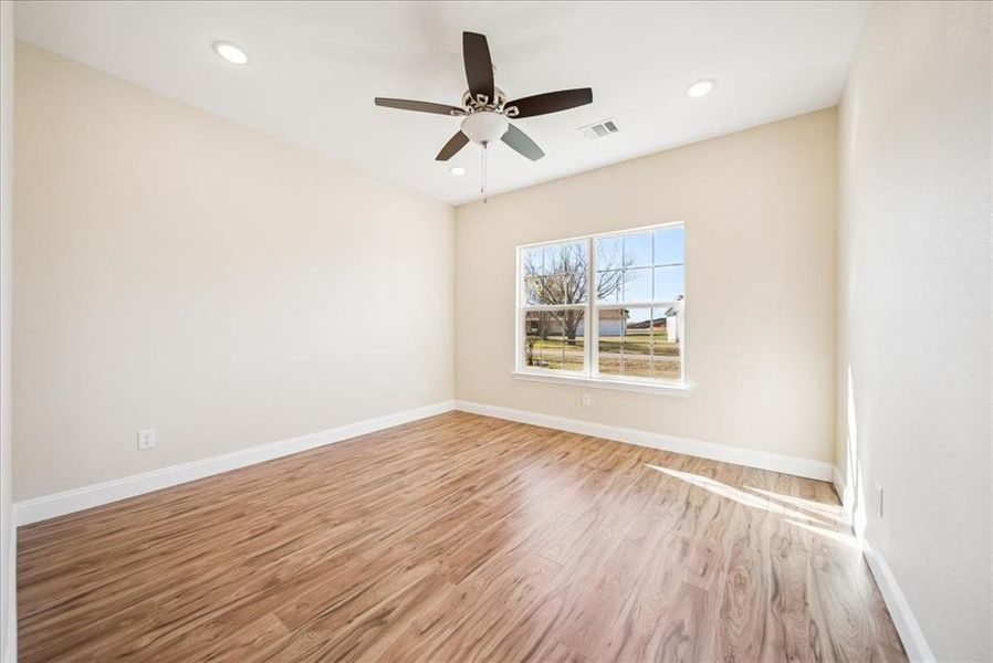 Unfurnished room with ceiling fan and light hardwood / wood-style floors