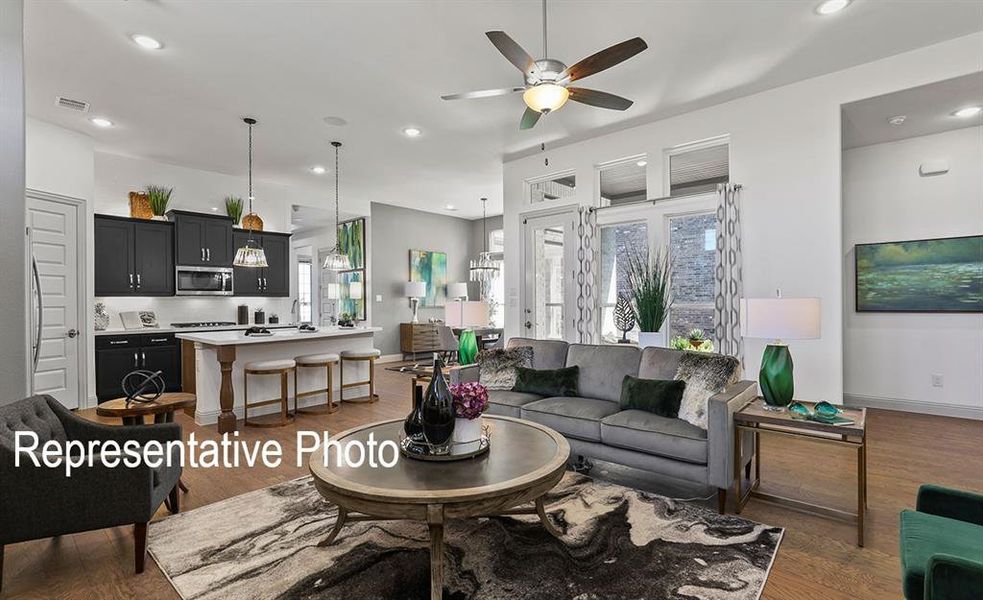 Open-concept living space featuring wood-finish flooring, recessed lighting, and a ceiling fan Open-concept living space featuring wood-finish flooring, recessed lighting, and a ceiling fan