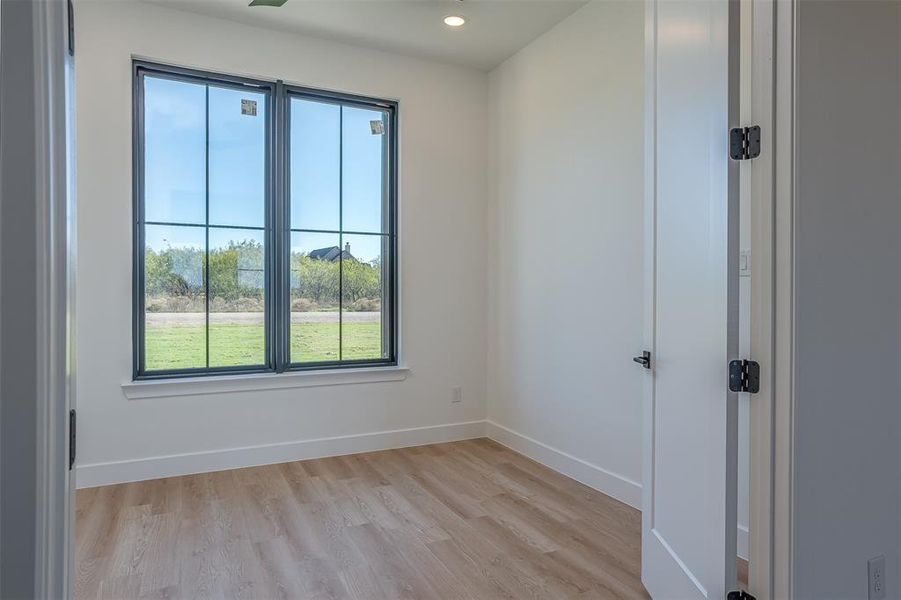 Unfurnished room featuring plenty of natural light and light hardwood / wood-style flooring