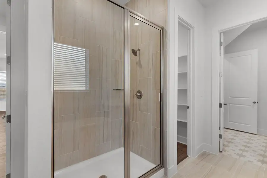 A well-lit shower enclosure with neutral-toned tiling offers a clean and contemporary bathing space.