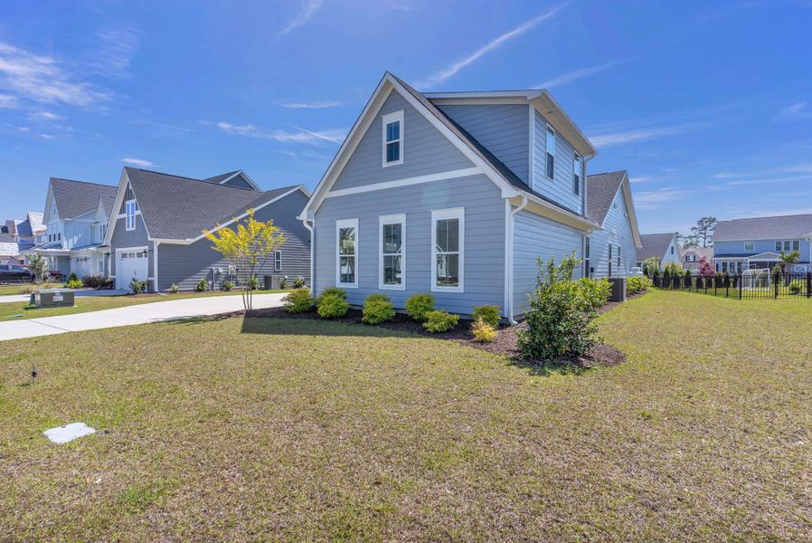 Representative exterior photo of a completed home built from the The Amherst by RobuckHomes in Windwater, Hampstead, NC (Image 22).