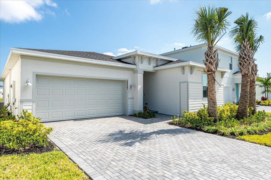 Front exterior of a new home in Seagrove: The Indies, Fort Pierce, FL, highlighting curb appeal (Image 1).