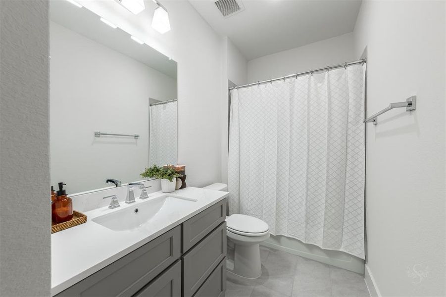 Second floor bathroom is just as pristine as the rest of the bathrooms!  All of the commodes in the home are upgraded, ensuring a high standard of comfort.