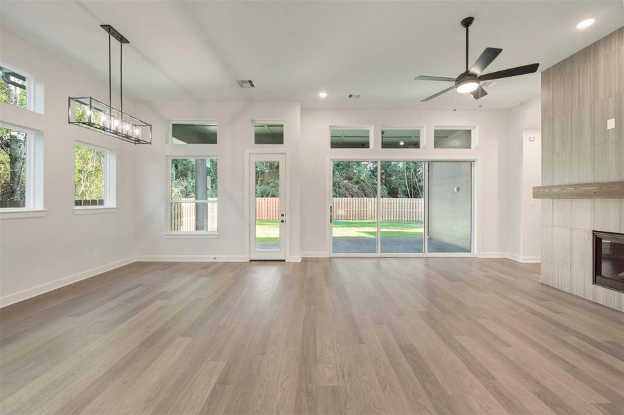 12 ft ceilings, lots of windows for light and cozy fireplace with low maintenance laminate floors, make this spacious Living and dining area a great place to hang out with friends and family!