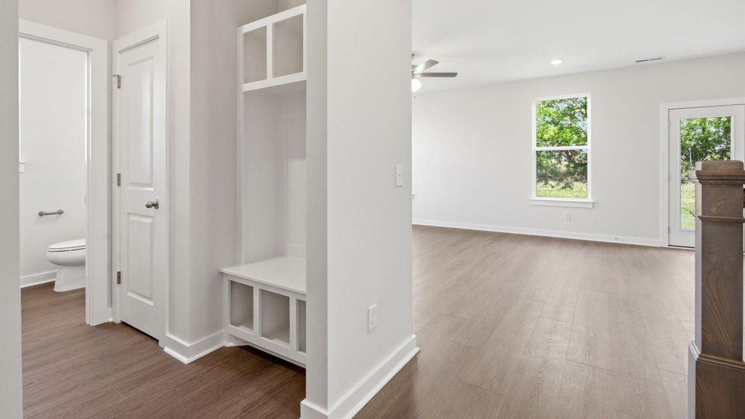 The powder room and Drop-zone with a linen closet, view of dining area and rear door The powder room and Drop-zone with a linen closet, view of dining area and rear door