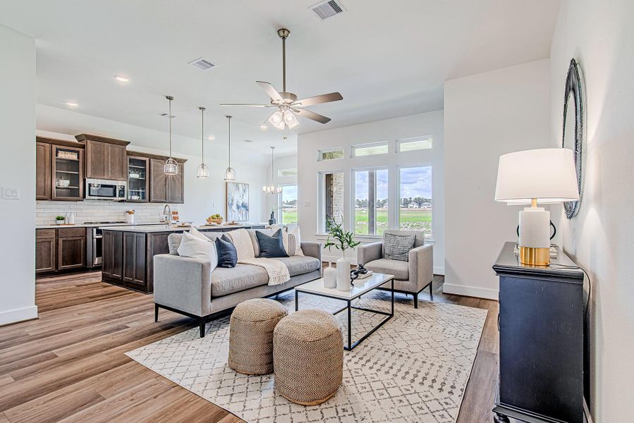 This open-concept living room is all about ease and elegance. Whether you're hosting or unwinding, the natural light and airy layout make it feel both elevated and effortless. This open-concept living room is all about ease and elegance. Whether you're hosting or unwinding, the natural light and airy layout make it feel both elevated and effortless.