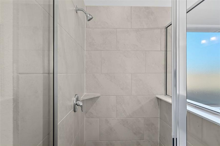 Full bath featuring a shower stall Full bath featuring a shower stall