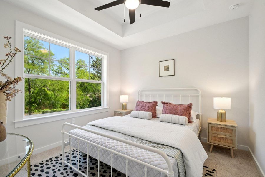 A comfortable guest bedroom with tray ceiling A comfortable guest bedroom with tray ceiling