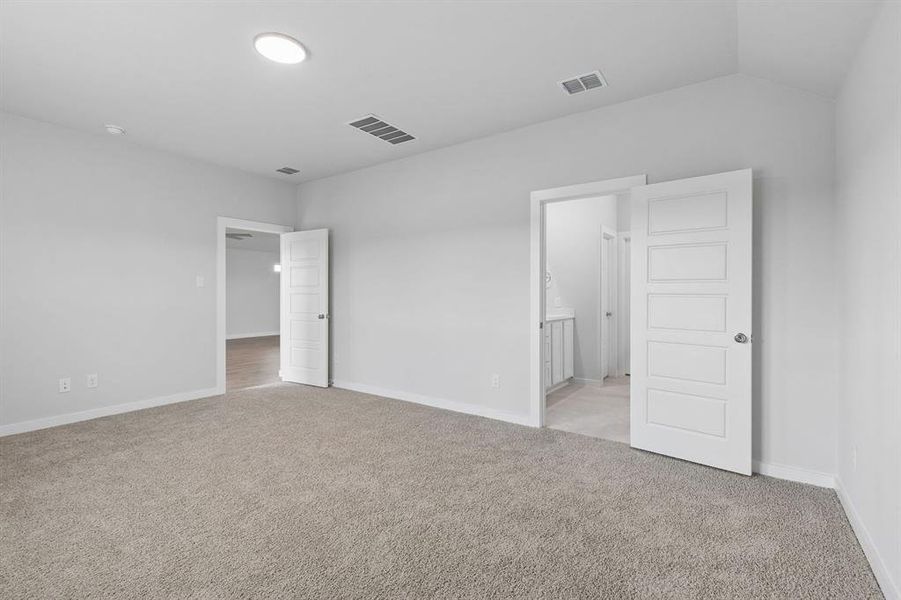 Primary Suite in the Oscar home plan by Trophy Signature Homes – REPRESENTATIVE PHOTO