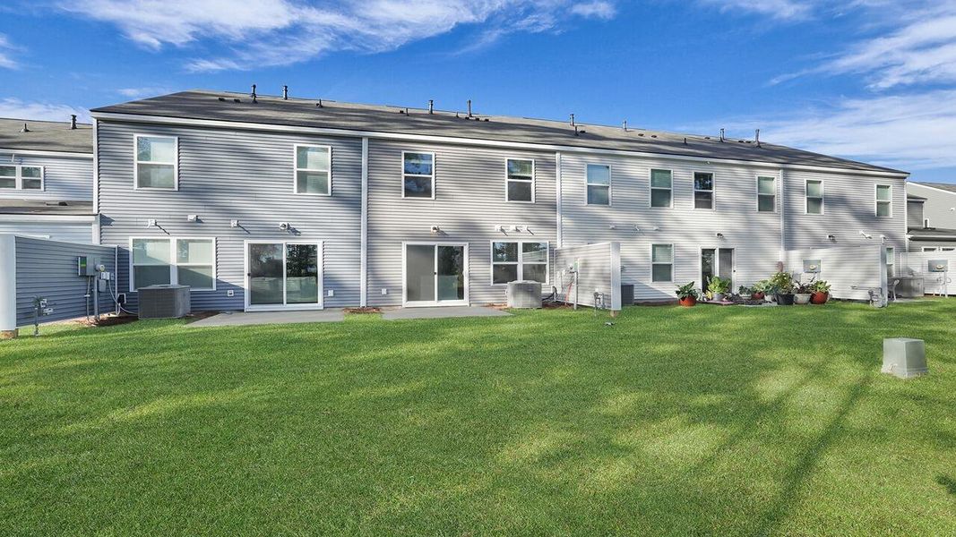 Exterior details and patio area of a home in Pine Hills Townhomes at Cane Bay, Summerville (Image 4).