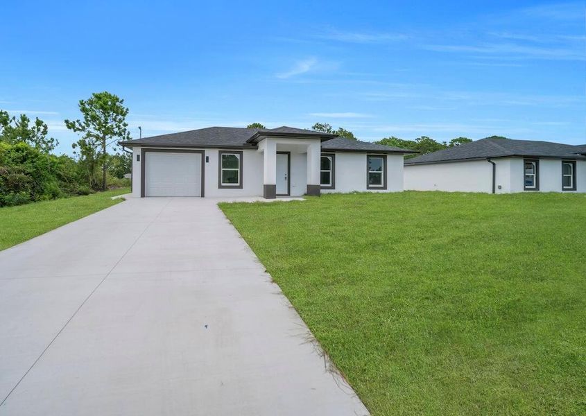 Front exterior of a new home in , Lehigh Acres, FL, highlighting curb appeal (Image 21).