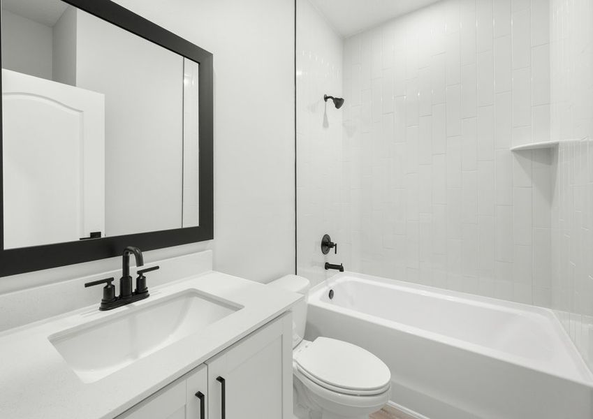 The secondary bathroom has a beautifully tiled shower
