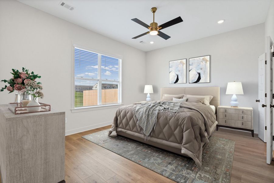 Bedroom with light wood-style flooring, ceiling fan, and recessed lighting