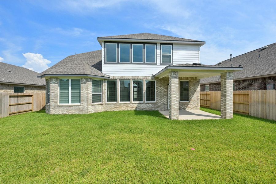 Front exterior of a new home in Kingdom Heights, Rosenberg, TX, highlighting curb appeal (Image 26). Front exterior of a new home in Kingdom Heights, Rosenberg, TX, highlighting curb appeal (Image 26).