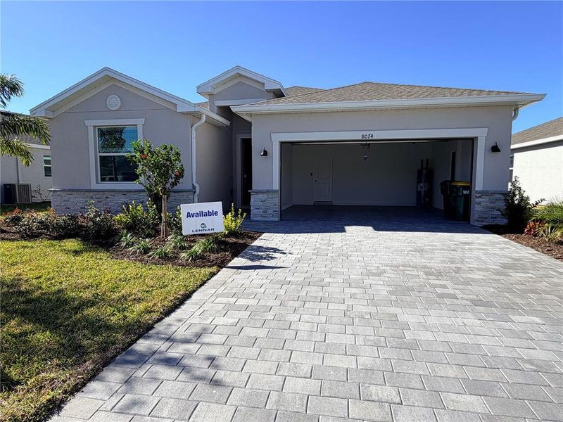 Front exterior of a new home in Island Lakes at Coco Bay: Executive Homes, Englewood, FL, highlighting curb appeal (Image 1). Front exterior of a new home in Island Lakes at Coco Bay: Executive Homes, Englewood, FL, highlighting curb appeal (Image 1).