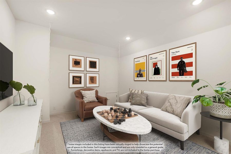Living room with gray sofa, leather chair, oval coffee table, and framed movie posters on white walls