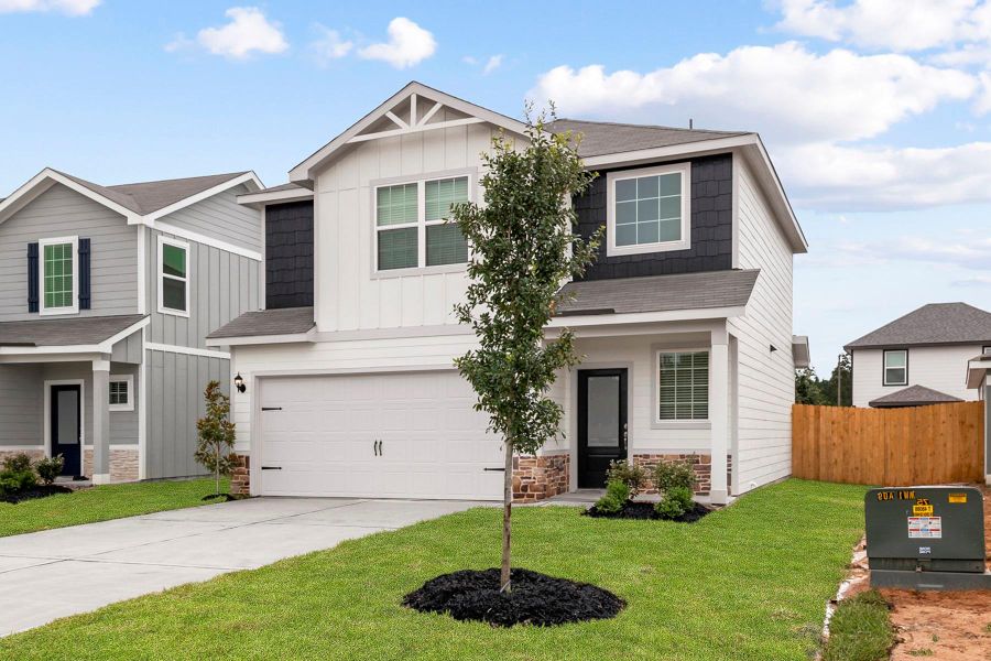 Front exterior of a new home in Magnolia Woods, Magnolia, TX, highlighting curb appeal (Image 2). Front exterior of a new home in Magnolia Woods, Magnolia, TX, highlighting curb appeal (Image 2).