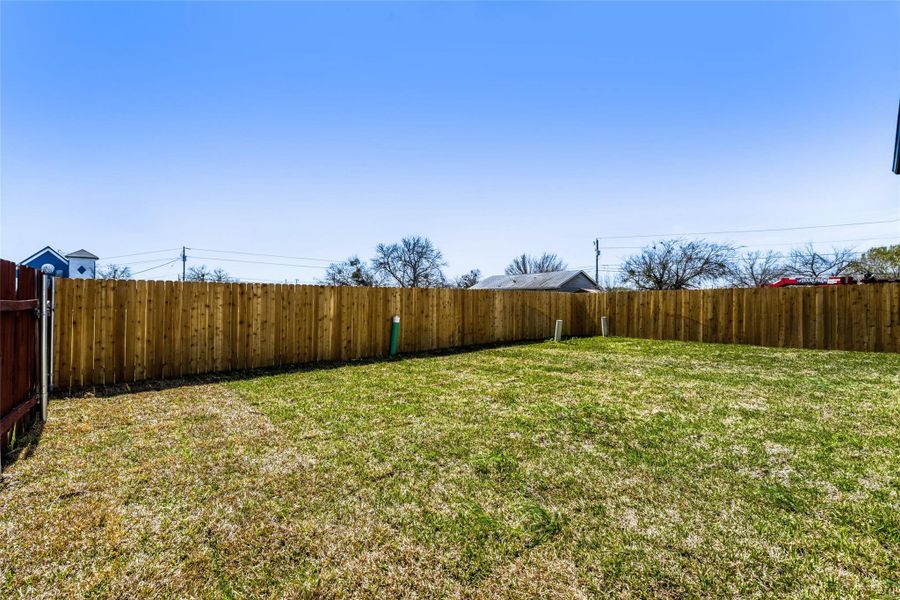 The spacious fenced-in yard with fresh sod is ready for your finishing touches - come make your landscaping dreams come true!