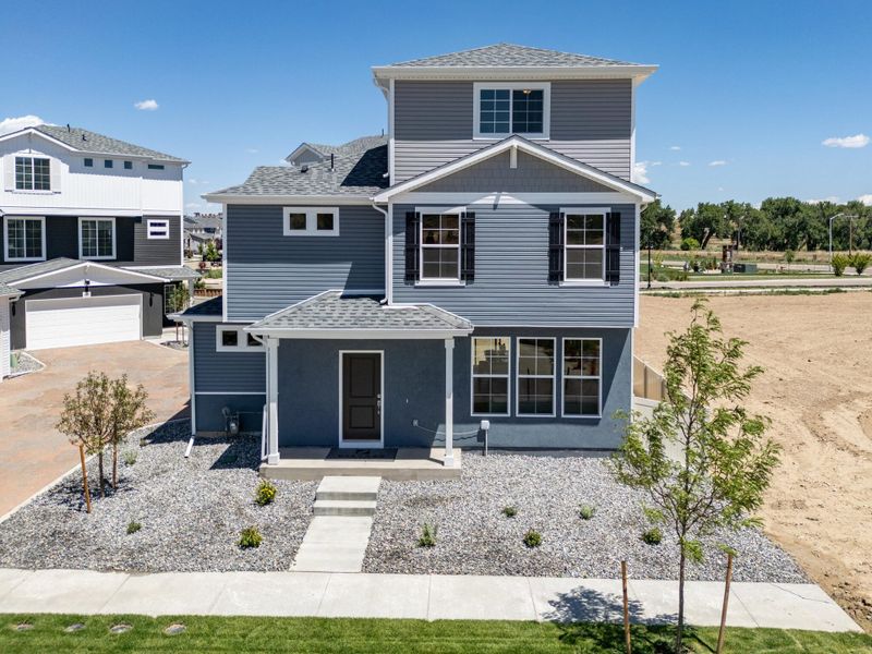 Front exterior of a new home in Thompson River Ranch, Johnstown, CO, highlighting curb appeal (Image 1). Front exterior of a new home in Thompson River Ranch, Johnstown, CO, highlighting curb appeal (Image 1).