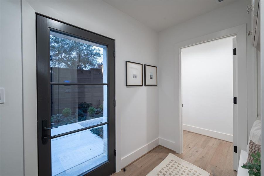 Doorway with light hardwood / wood-style flooring