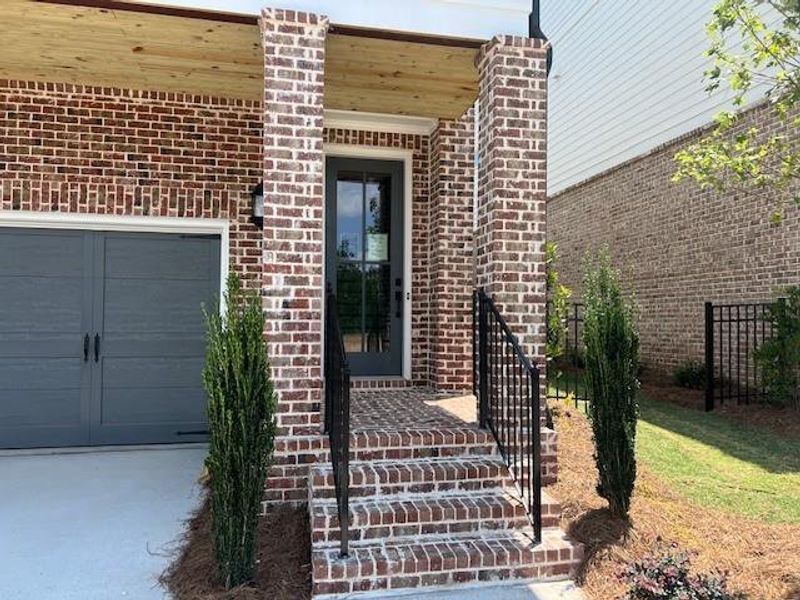Front exterior of a new home in Palisades Single Family, Cumming, GA, highlighting curb appeal (Image 32).