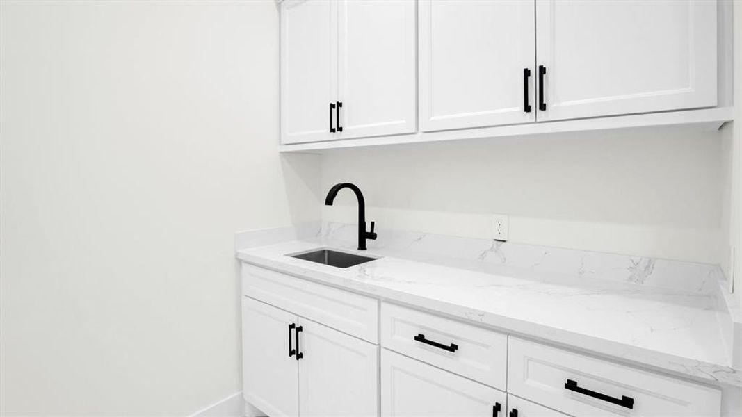 Large laundry room with sink and plenty of built-in storage