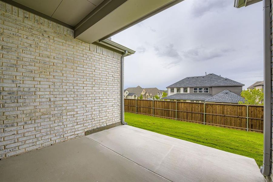 Fenced backyard featuring a patio and a residential view