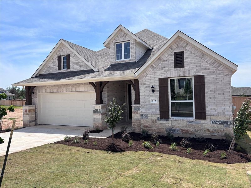 Front exterior of a new home in The Colony, Bastrop, TX, highlighting curb appeal (Image 2). Front exterior of a new home in The Colony, Bastrop, TX, highlighting curb appeal (Image 2).