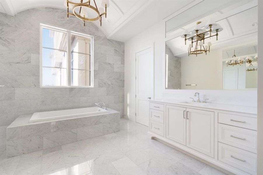 Dual vanity areas feature marble countertops, statement lighting, and furniture style built in cabinetry. (photo of interior model home with smaller floor plan)