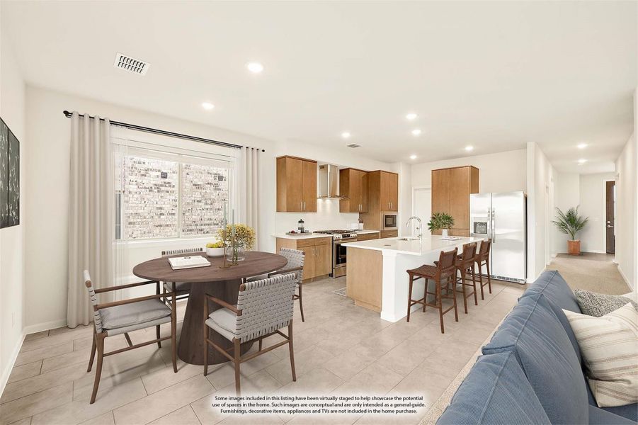 Open-concept kitchen and dining area with wood cabinets, white island, and round dining table on tile floors Open-concept kitchen and dining area with wood cabinets, white island, and round dining table on tile floors