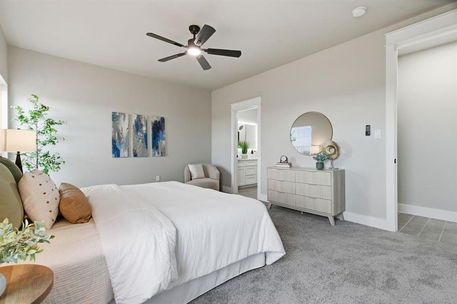 Bedroom with light carpet, a ceiling fan, and ensuite bath