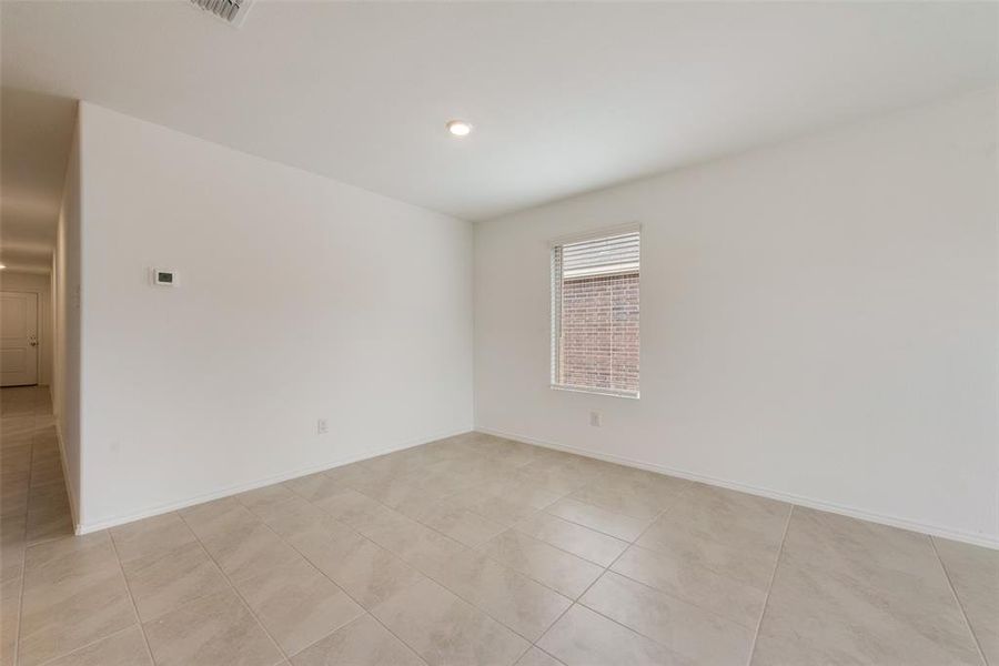 Empty room with light tile patterned floors