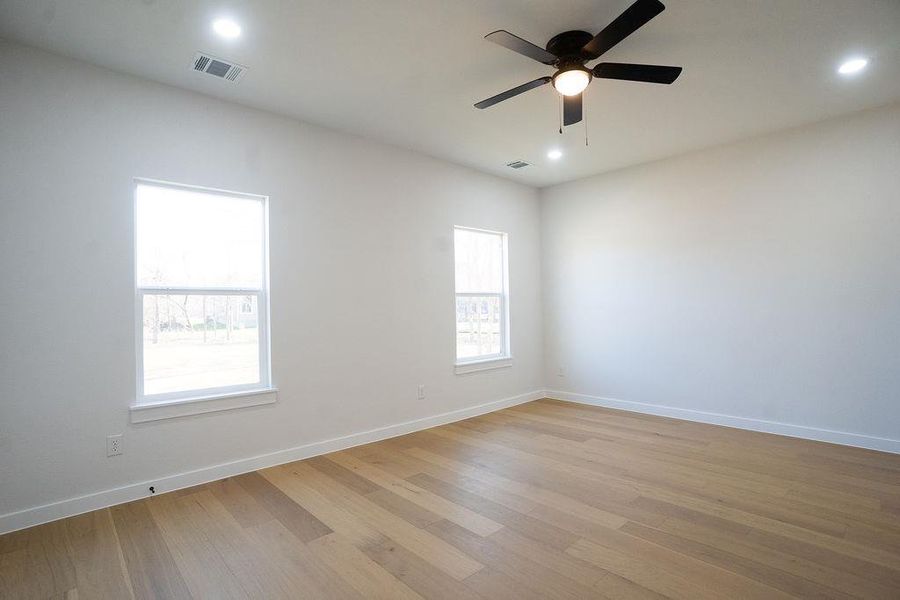 Empty room featuring light wood-style floors, recessed lighting, and ceiling fan