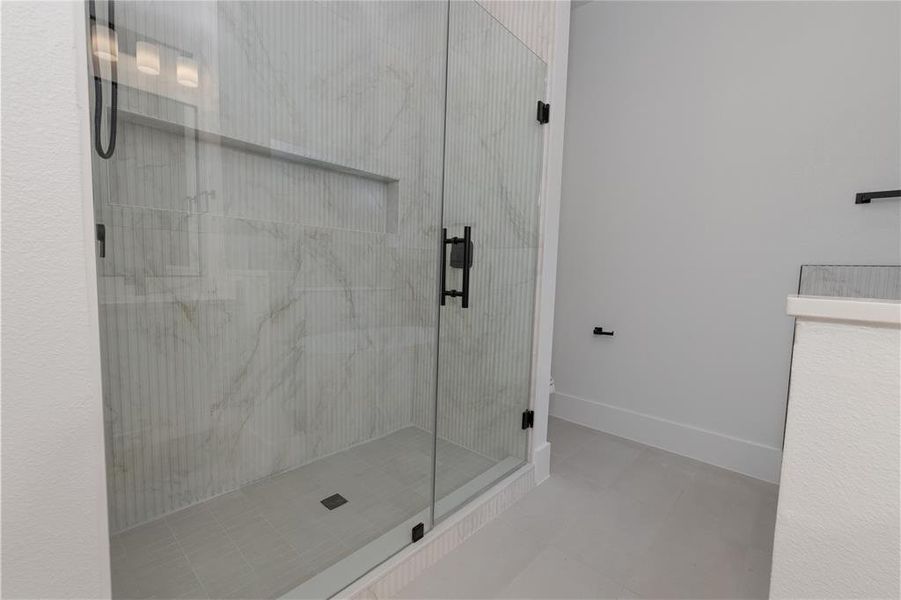 Bathroom featuring a stall shower and tile patterned flooring