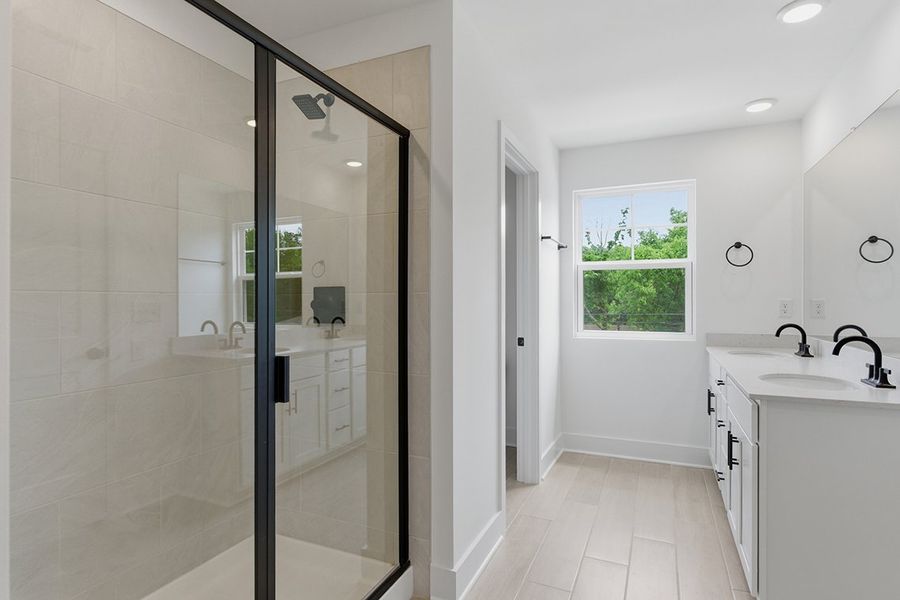 A bathroom with a glass shower. A bathroom with a glass shower.