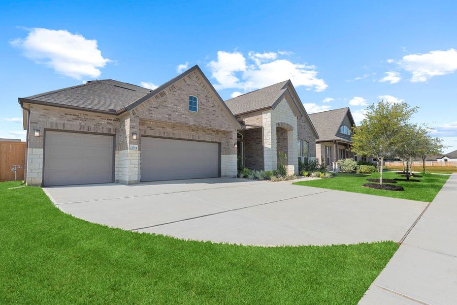 Wide concrete driveway leads to the expansive 3-car garage, complemented by a lush green lawn and pristine exterior. This Energy Star qualified home is designed for low maintenance and long-lasting beauty. Wide concrete driveway leads to the expansive 3-car garage, complemented by a lush green lawn and pristine exterior. This Energy Star qualified home is designed for low maintenance and long-lasting beauty.