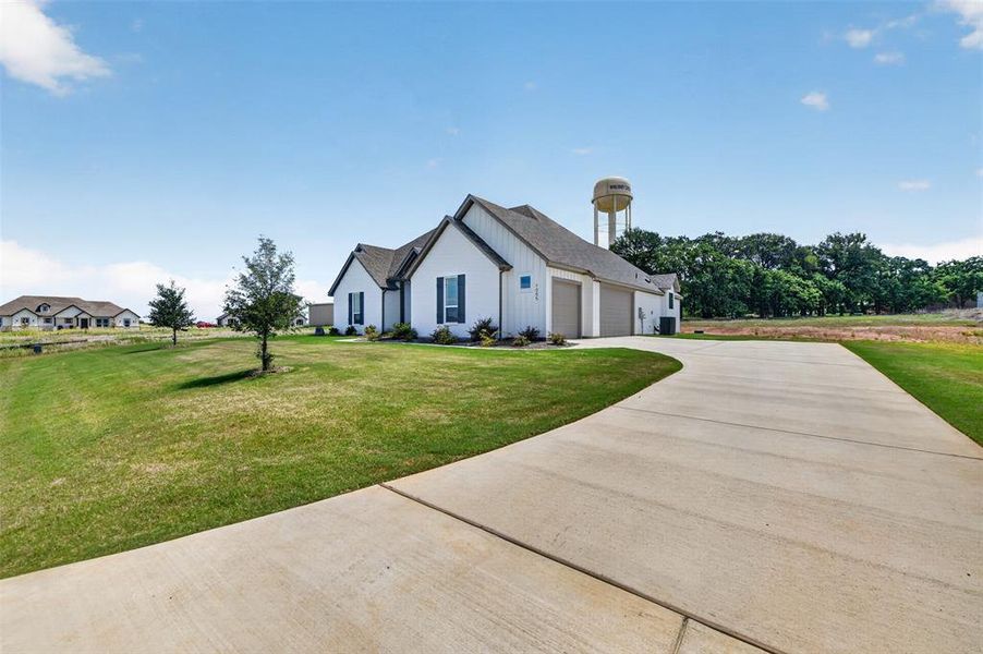 Front exterior of a new home in Thomas Estates, Springtown, TX, highlighting curb appeal (Image 22). Front exterior of a new home in Thomas Estates, Springtown, TX, highlighting curb appeal (Image 22).