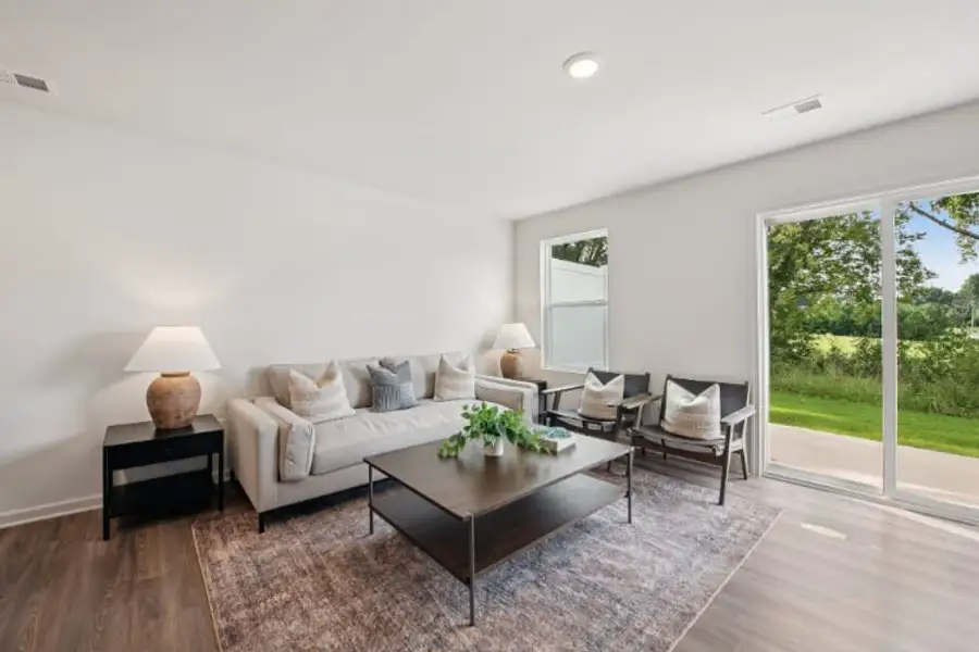 A living room with a large glass door.