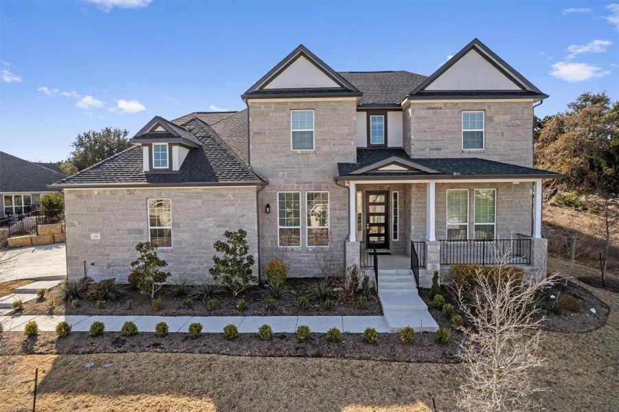 View of front of home featuring a porch and stone siding View of front of home featuring a porch and stone siding