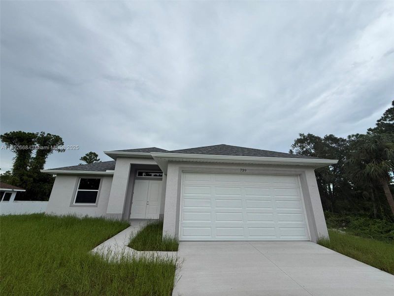 Front exterior of a new home in , Lehigh Acres, FL, highlighting curb appeal (Image 1). Front exterior of a new home in , Lehigh Acres, FL, highlighting curb appeal (Image 1).