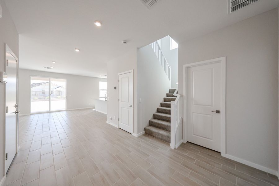 A large empty room with white doors.