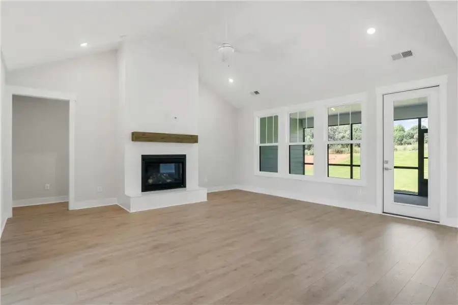 A spacious living area features high ceilings, a c A spacious living area features high ceilings, a c