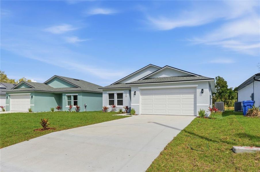 Front exterior of a new home in , Osteen, FL, highlighting curb appeal (Image 1). Front exterior of a new home in , Osteen, FL, highlighting curb appeal (Image 1).