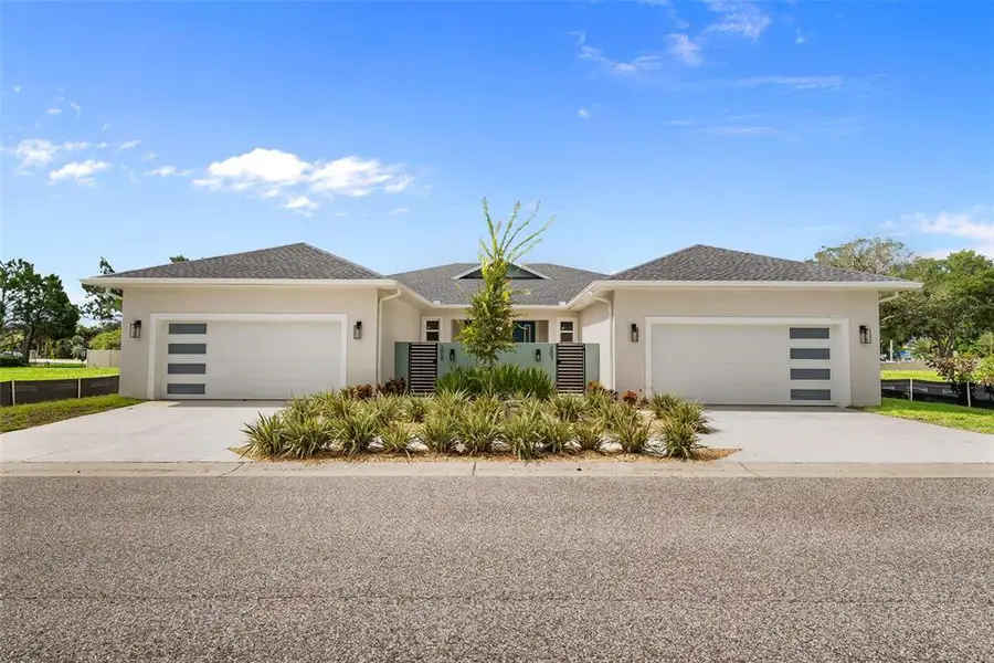 Front exterior of a new home in , Tarpon Springs, FL, highlighting curb appeal (Image 24).