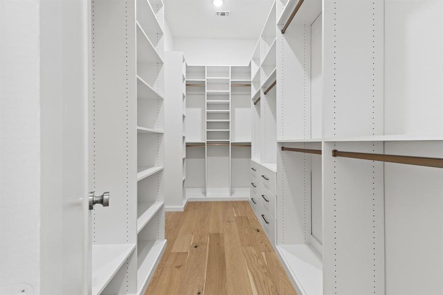 Spacious closet with light wood-style floors