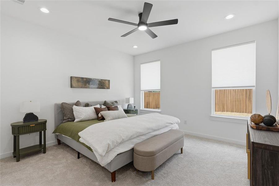Bedroom featuring a ceiling fan, light carpet, and recessed lighting Bedroom featuring a ceiling fan, light carpet, and recessed lighting